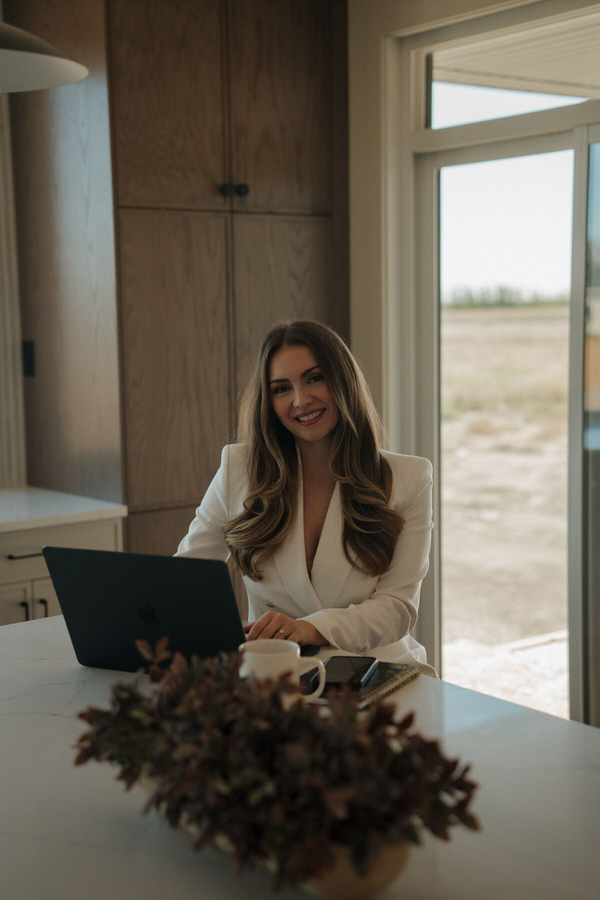 Stephanie Johnston working on her laptop in a kitchen